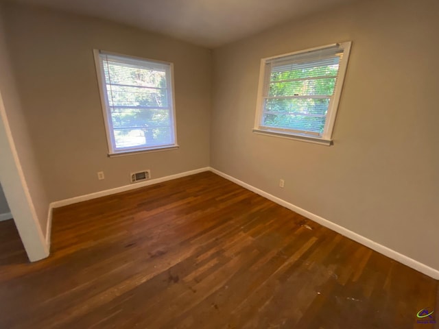 empty room with dark wood-type flooring