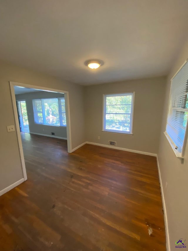 empty room with dark wood-type flooring