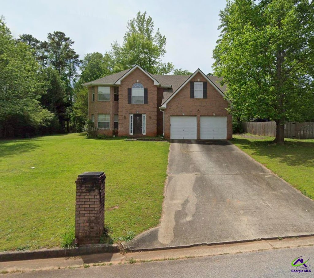 view of front of home with a front lawn and a garage