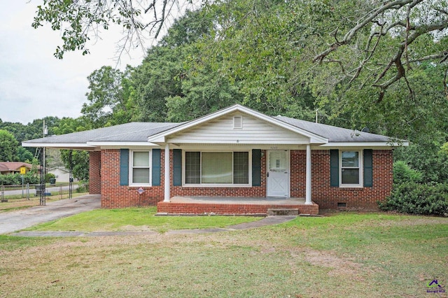 ranch-style house with a front yard and covered porch