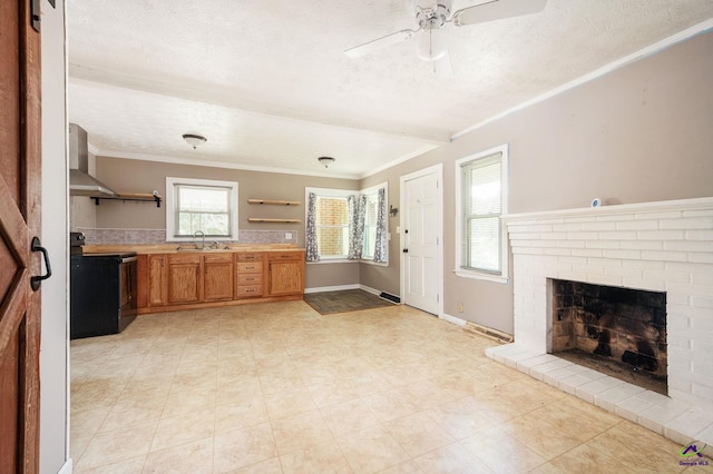 kitchen with sink, a textured ceiling, wall chimney exhaust hood, black / electric stove, and crown molding