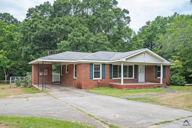 single story home featuring covered porch and a carport