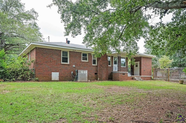 back of property featuring a yard