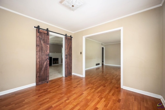 spare room featuring crown molding and wood-type flooring