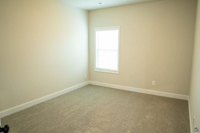 unfurnished bedroom featuring baseboards, light carpet, and ensuite bathroom