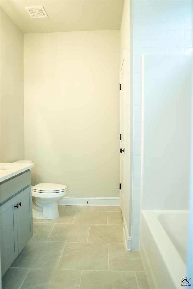 bathroom with vanity, baseboards, and tile patterned floors