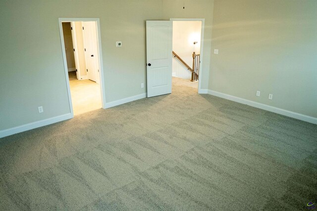 bathroom featuring a walk in closet, a sink, double vanity, baseboards, and a stall shower
