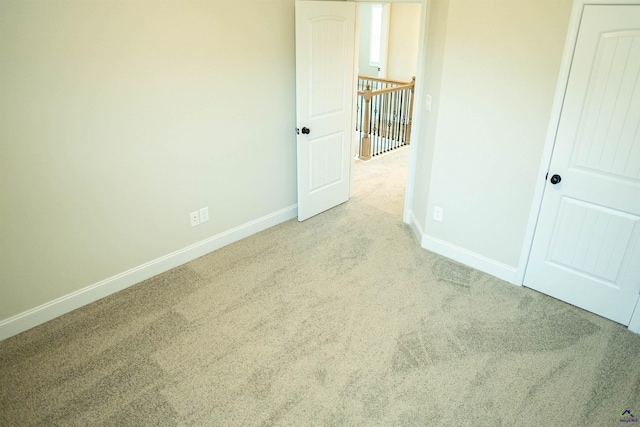 carpeted spare room with baseboards