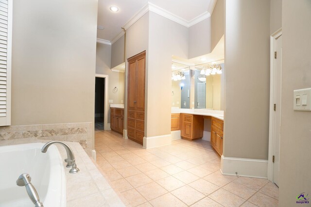 bathroom featuring a towering ceiling, a washtub, tile patterned floors, vanity, and ornamental molding