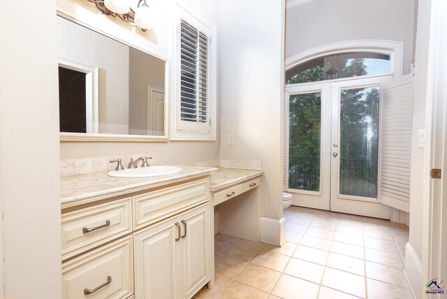 bathroom featuring vanity, french doors, toilet, and tile patterned flooring