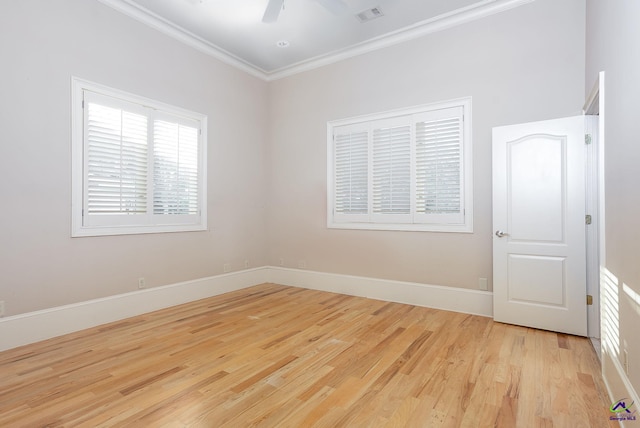 empty room with crown molding, light wood-type flooring, and ceiling fan