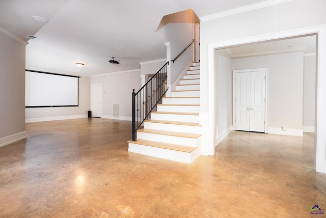 stairs featuring concrete floors and ornamental molding