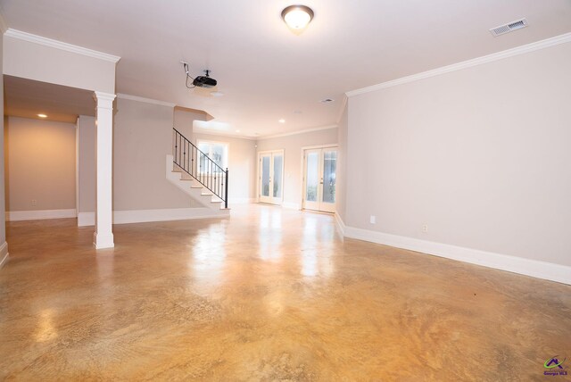 unfurnished living room featuring crown molding and decorative columns