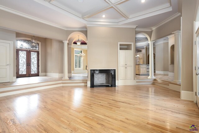 unfurnished living room featuring light hardwood / wood-style flooring, french doors, and a healthy amount of sunlight