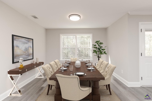 dining area featuring hardwood / wood-style flooring and a healthy amount of sunlight