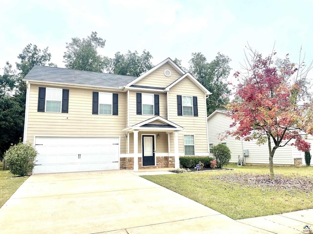 craftsman house with an attached garage, driveway, stone siding, and a front yard
