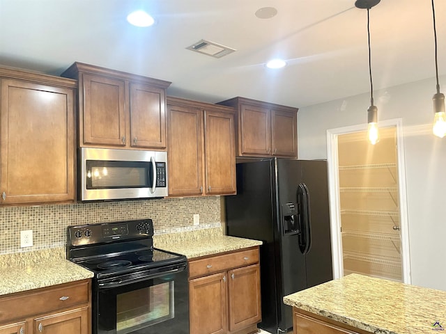 kitchen with backsplash, black appliances, light stone countertops, and visible vents