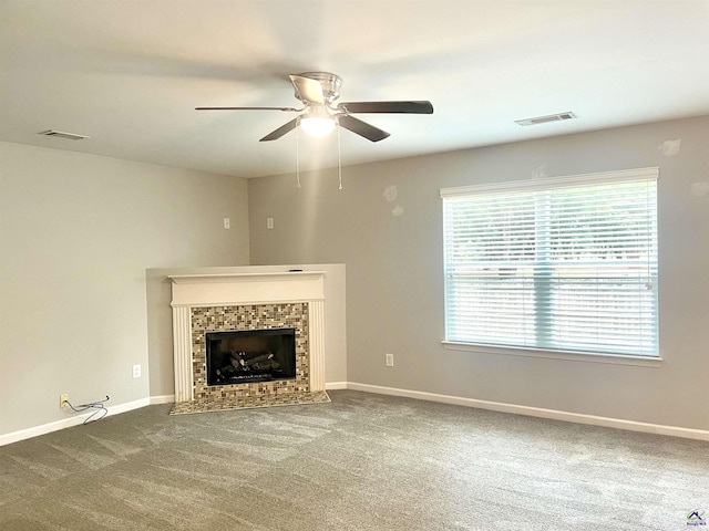 unfurnished living room featuring visible vents, a ceiling fan, and a wealth of natural light