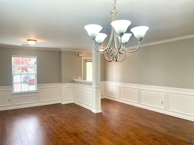 unfurnished room with a chandelier, wainscoting, a healthy amount of sunlight, and dark wood-type flooring