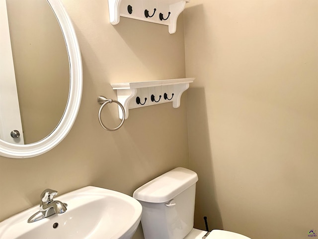 half bathroom with a sink and toilet