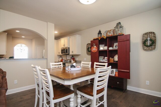 dining room with dark hardwood / wood-style flooring