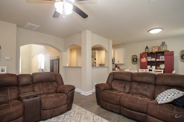 living room featuring hardwood / wood-style floors and ceiling fan