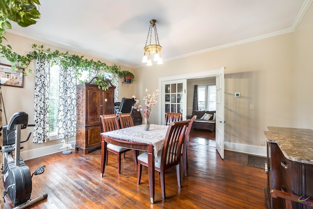 dining space with ornamental molding, a chandelier, french doors, and dark hardwood / wood-style flooring