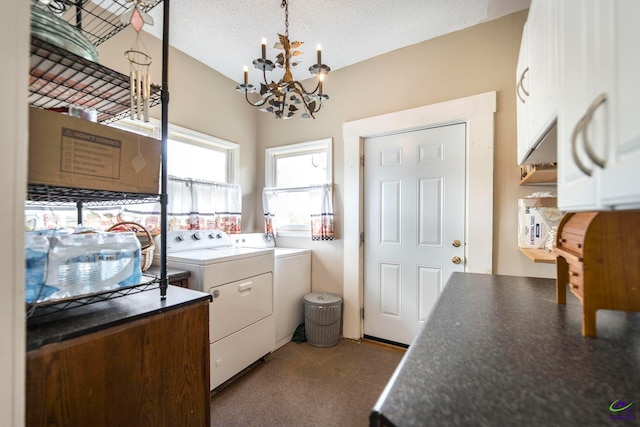 laundry area featuring separate washer and dryer, a textured ceiling, light carpet, cabinets, and an inviting chandelier