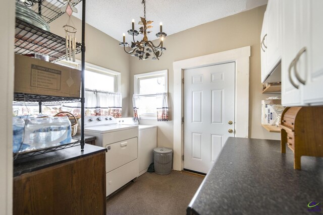 429 N Dooly St, Montezuma, GA 31063 - kitchen featuring washer and dryer, white cabinets, a chandelier, dark countertops, and vaulted ceiling