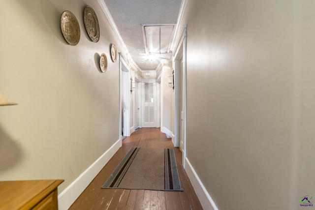 corridor featuring ornamental molding, a textured ceiling, and hardwood / wood-style flooring