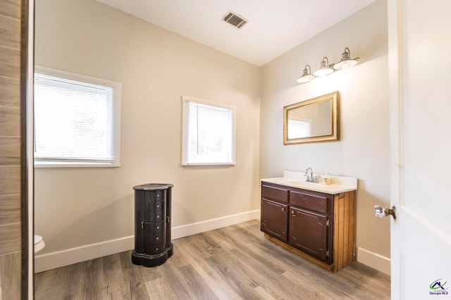 bathroom with vanity, hardwood / wood-style flooring, and toilet