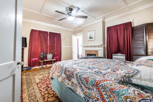 bedroom featuring hardwood / wood-style flooring, ceiling fan, coffered ceiling, and crown molding