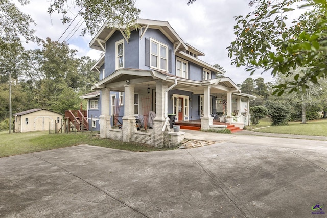 429 N Dooly St, Montezuma, GA 31063 - view of front of property with a porch, a front lawn, stucco siding, brick siding, and an outdoor structure