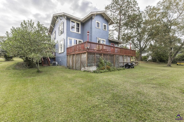 429 N Dooly St, Montezuma, GA 31063 - rear view of property featuring a wooden deck, central AC unit, a lawn, stucco siding, and stairway