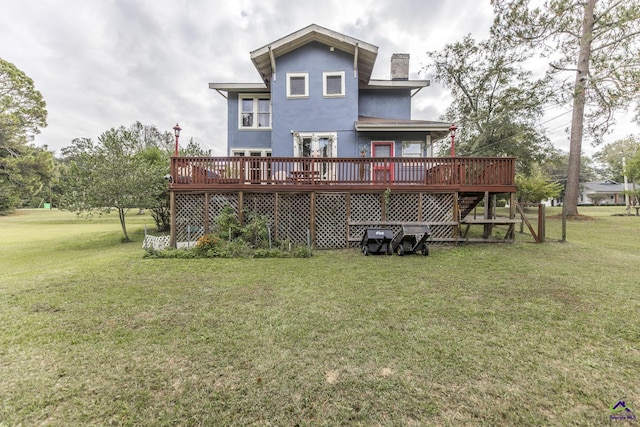 429 N Dooly St, Montezuma, GA 31063 - back of property featuring a chimney, a wooden deck, a yard, and stucco siding