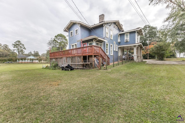 back of property with a yard and a deck