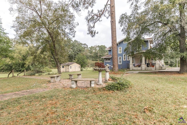 view of yard with a wooden deck and a shed