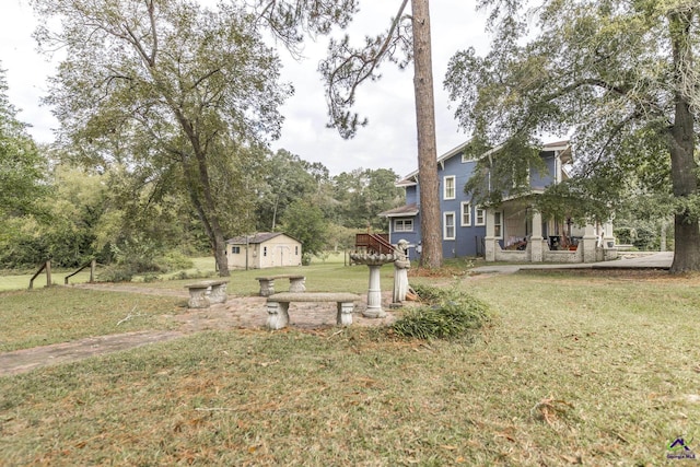 429 N Dooly St, Montezuma, GA 31063 - view of green lawn featuring an outdoor structure, view of scattered trees, and a storage unit