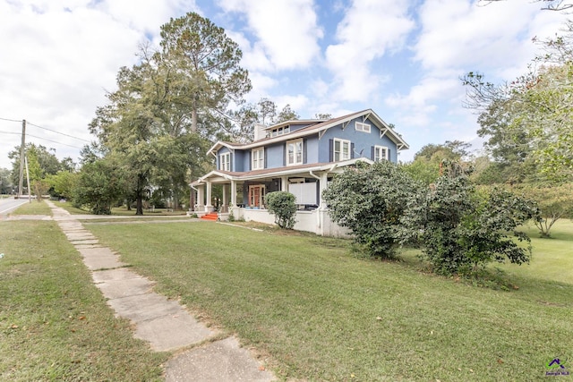 view of front of property with a front yard and covered porch