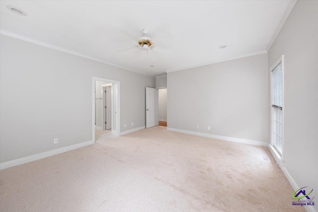 carpeted empty room featuring crown molding and ceiling fan