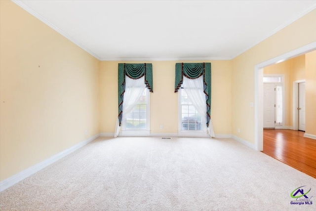 spare room featuring light hardwood / wood-style floors and ornamental molding