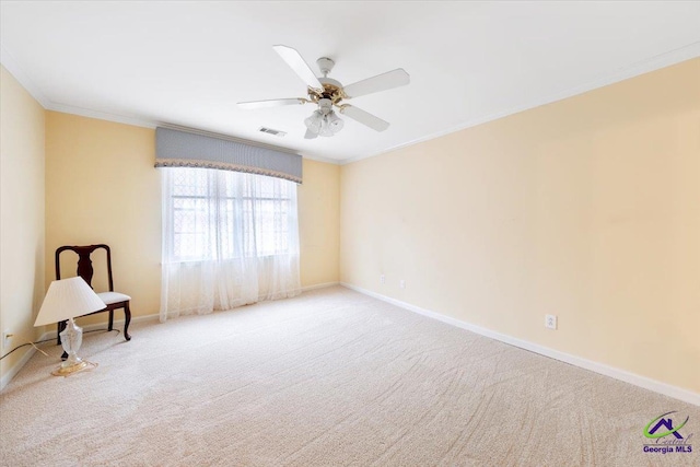 carpeted empty room featuring ceiling fan and ornamental molding