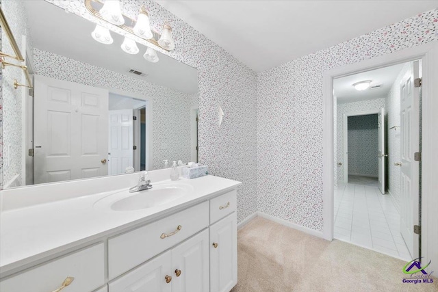 bathroom featuring tile patterned flooring and vanity