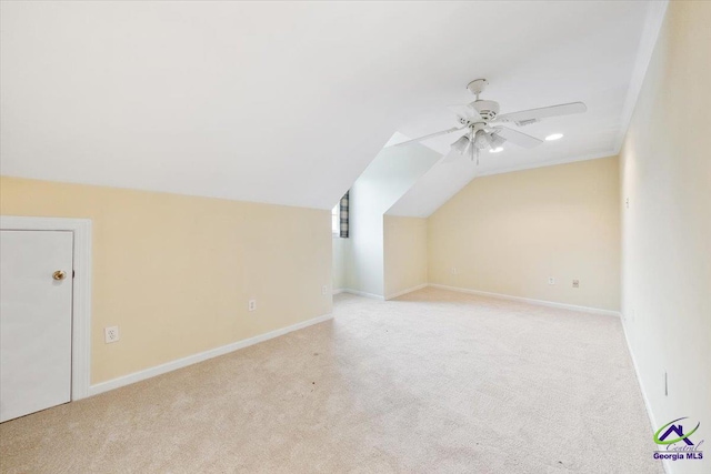 additional living space with light carpet and vaulted ceiling