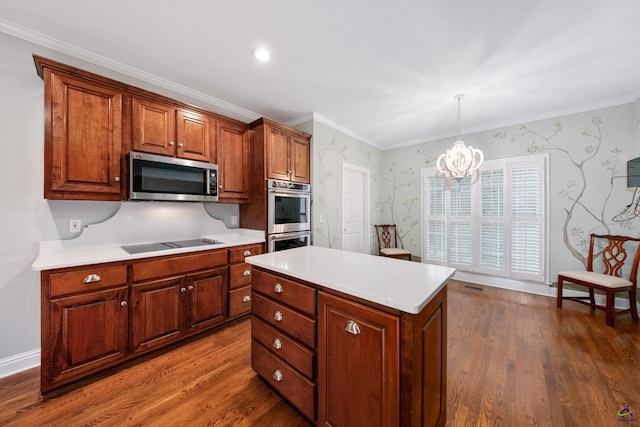 kitchen featuring a center island, hanging light fixtures, dark hardwood / wood-style flooring, a notable chandelier, and appliances with stainless steel finishes