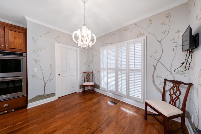 living area featuring crown molding, dark hardwood / wood-style floors, and an inviting chandelier