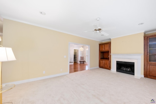 unfurnished living room featuring ceiling fan, light colored carpet, and ornamental molding