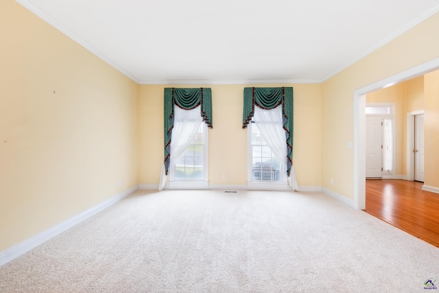 spare room with light hardwood / wood-style floors and ornamental molding