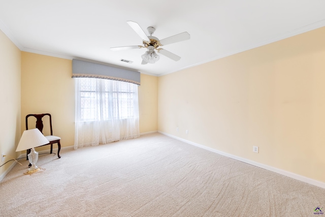 carpeted empty room with ceiling fan and ornamental molding