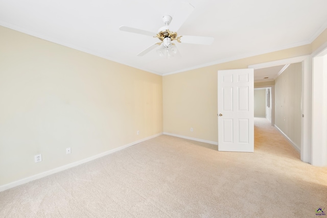 carpeted empty room with ceiling fan and ornamental molding